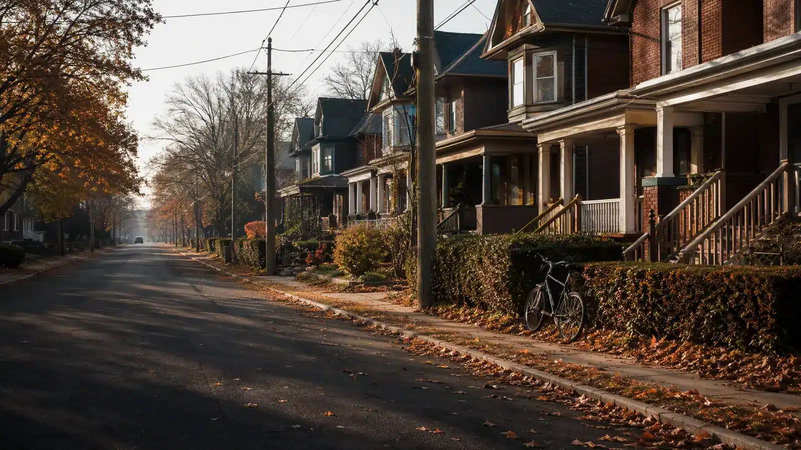 Illustrative residential street in Canada with porched houses and fallen autumn leaves