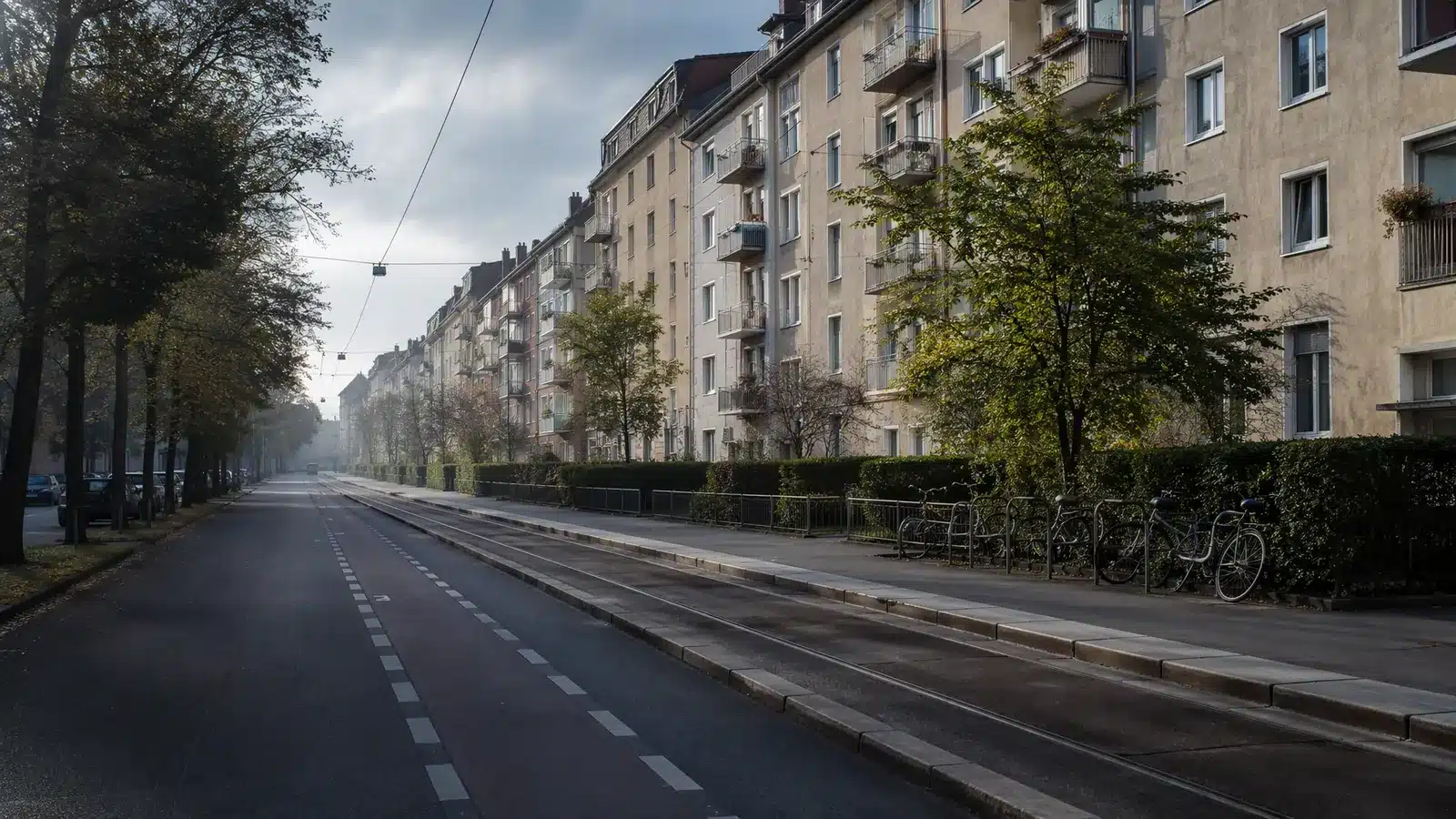 Illustrative residential street in Germany with apartment facades, a cycle lane and parked bicycles