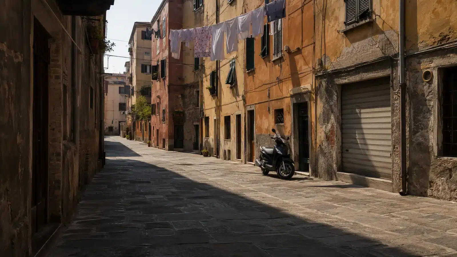 Illustrative residential lane in Italy with shuttered windows, laundry and worn stone paving