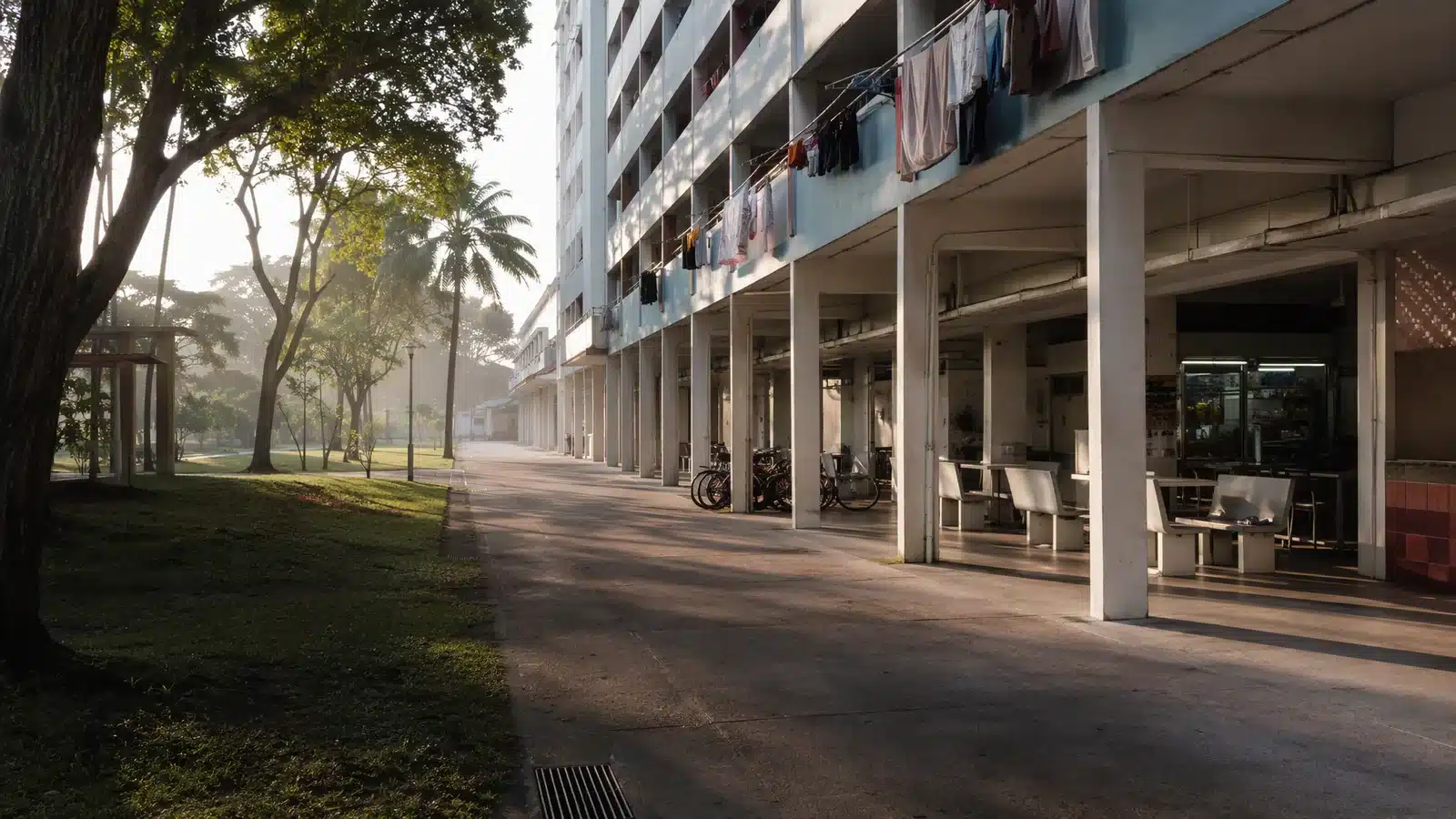 Illustrative public housing walkway in Singapore with a void deck, bicycle racks and rain trees